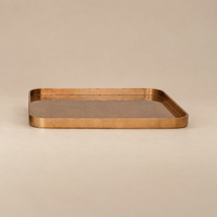 A rectangular copper tray with rounded corners and a hammered texture, shown on a neutral beige background.