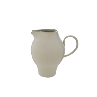 Beige ceramic pitcher on a white background