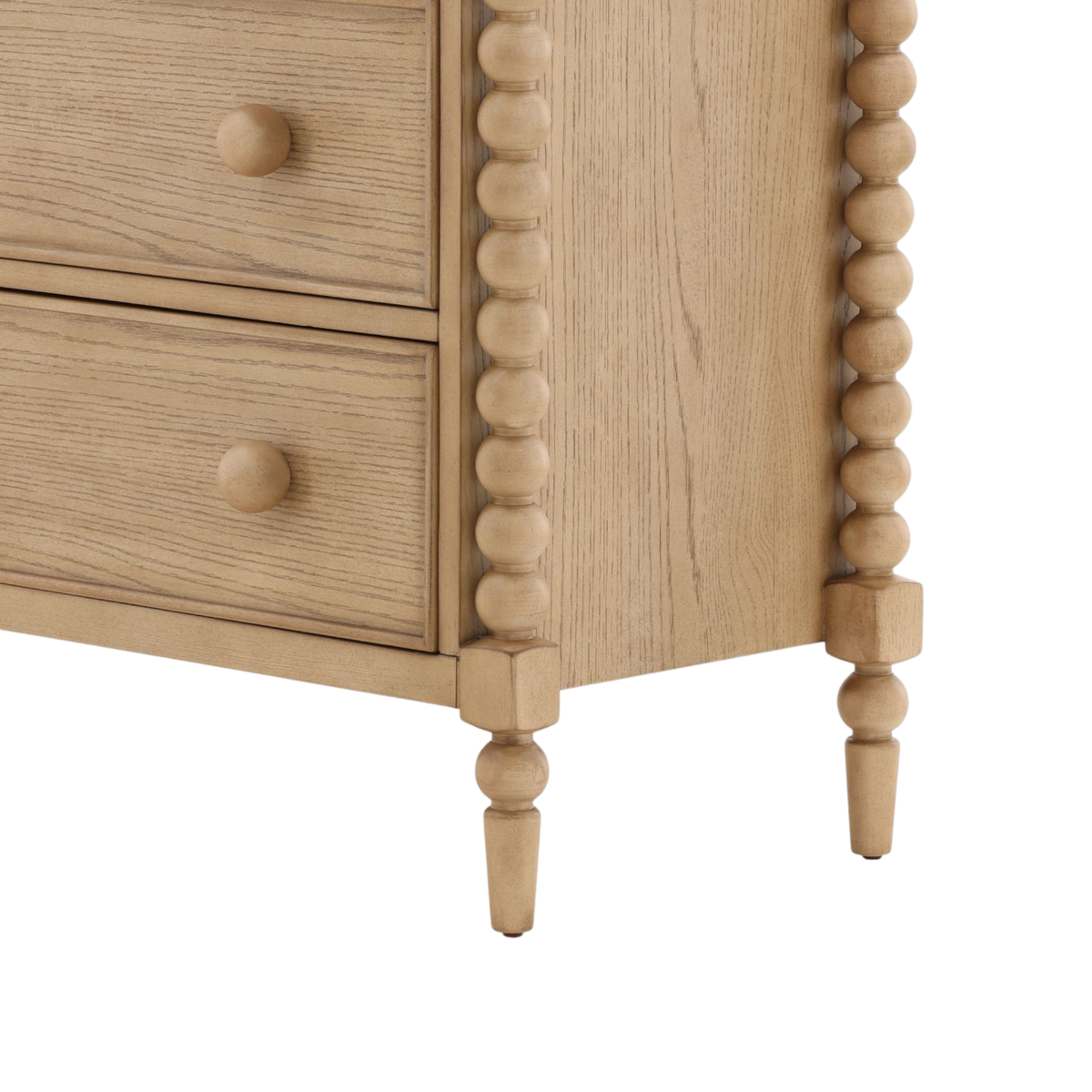 Wooden dresser with spindle legs on a white background
